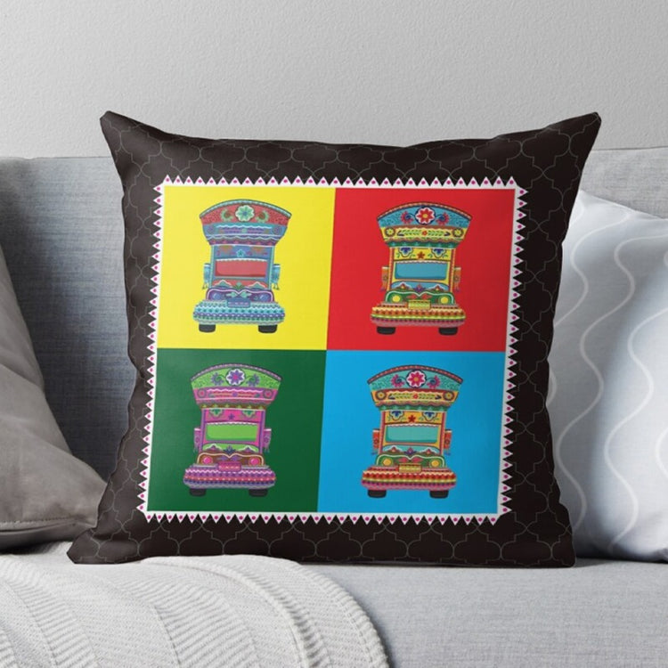 Black cushion cover with four colourful truck illustrations in square panels.