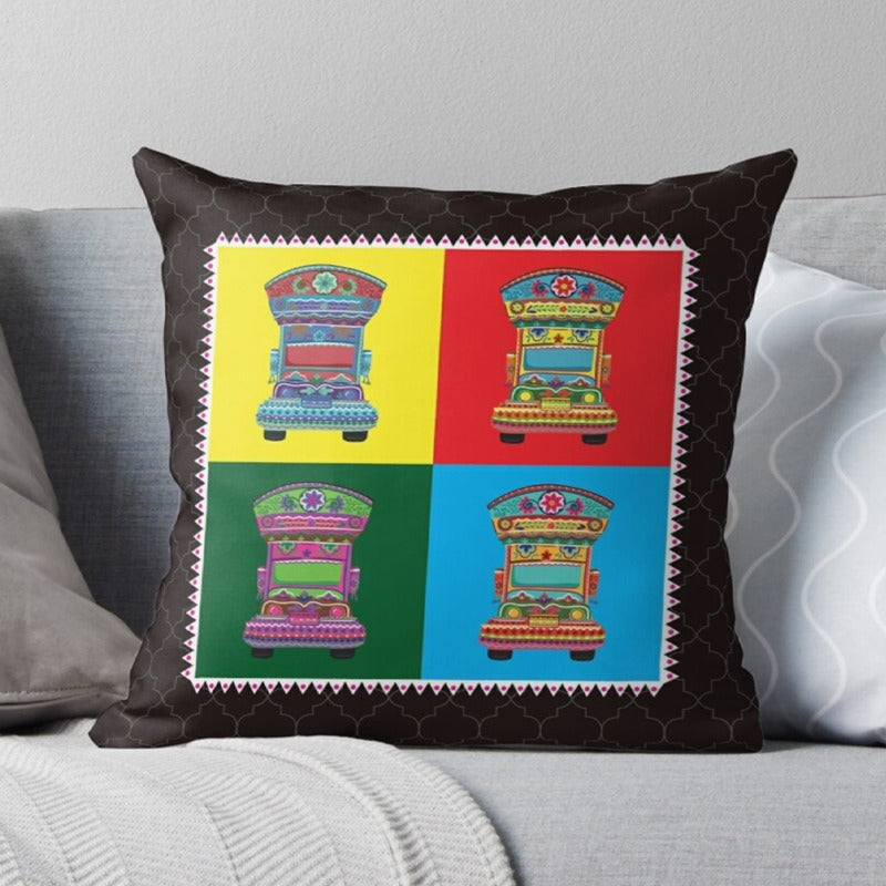 Black cushion cover with four colourful truck illustrations in square panels.