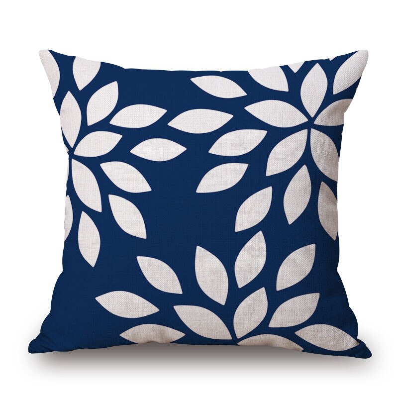 Navy cushion cover with white leaf shapes.