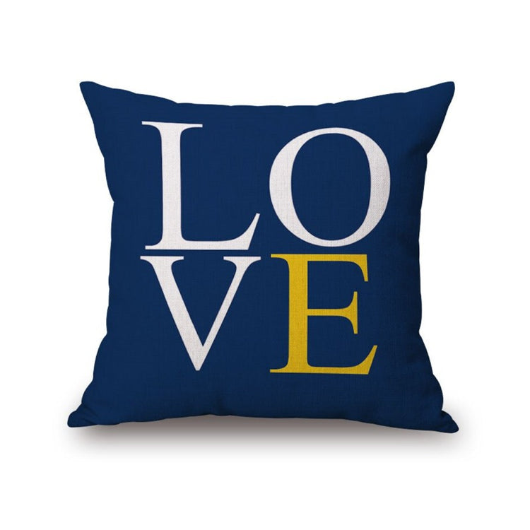 Navy cushion cover with large white and yellow LOVE lettering.