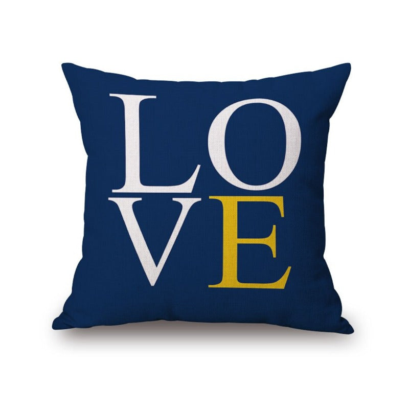 Navy cushion cover with large white and yellow LOVE lettering.