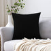 Plain black cushion cover displayed on a white sofa.