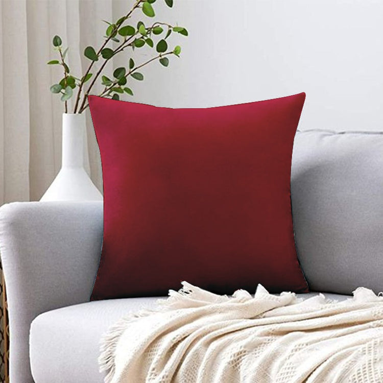 Plain burgundy cushion cover displayed on a white sofa.