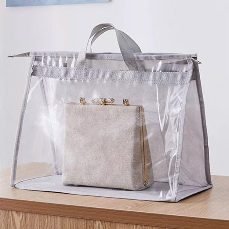 Handbag inside a clear grey-trimmed storage cover on a shelf.