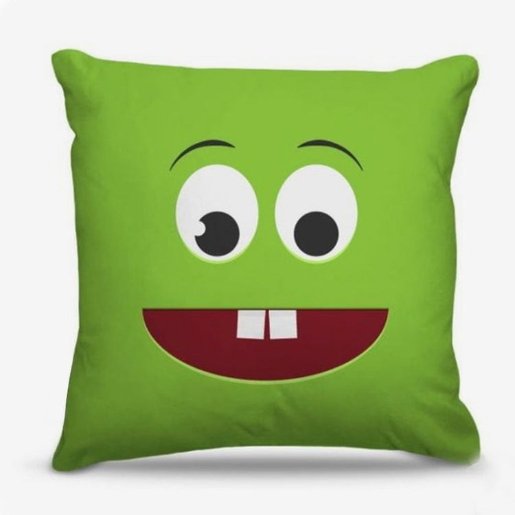 Green cushion cover with a smiling cartoon face and two square teeth.