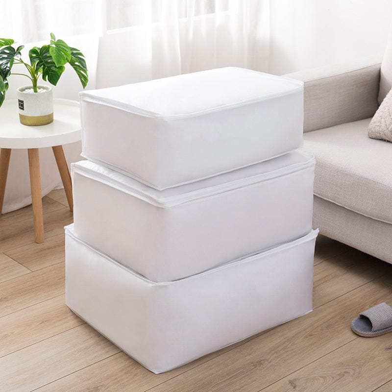 Three white fabric storage cubes stacked beside a sofa.