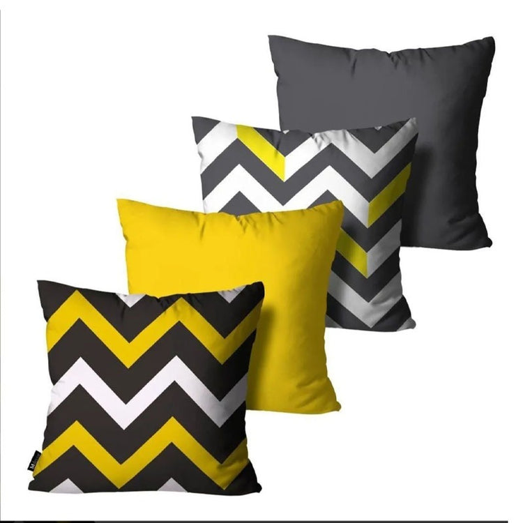 Four yellow, grey and white cushion covers with plain and zigzag designs.