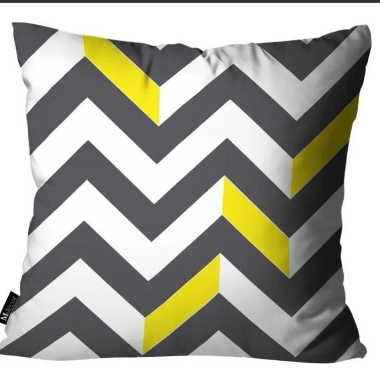 Grey cushion cover with white zigzag stripes and yellow accents.