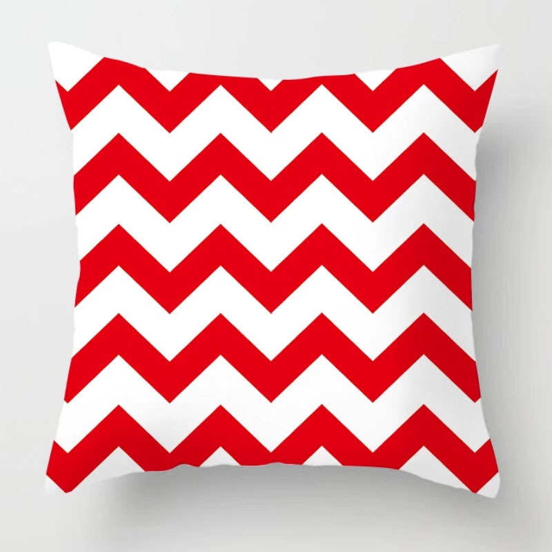 Cushion cover with bold red and white zigzag stripes.