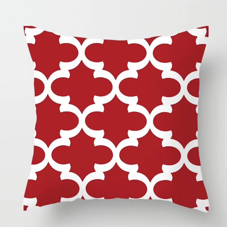 Red cushion cover with a white interlocking quatrefoil pattern.