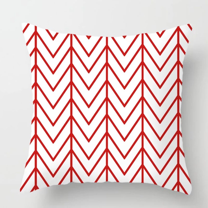 White cushion cover with thin red chevron lines.