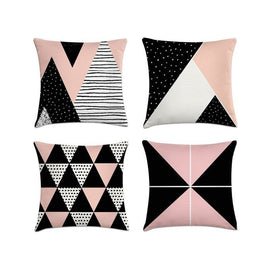 Four pink, black and white cushion covers with assorted triangle patterns.