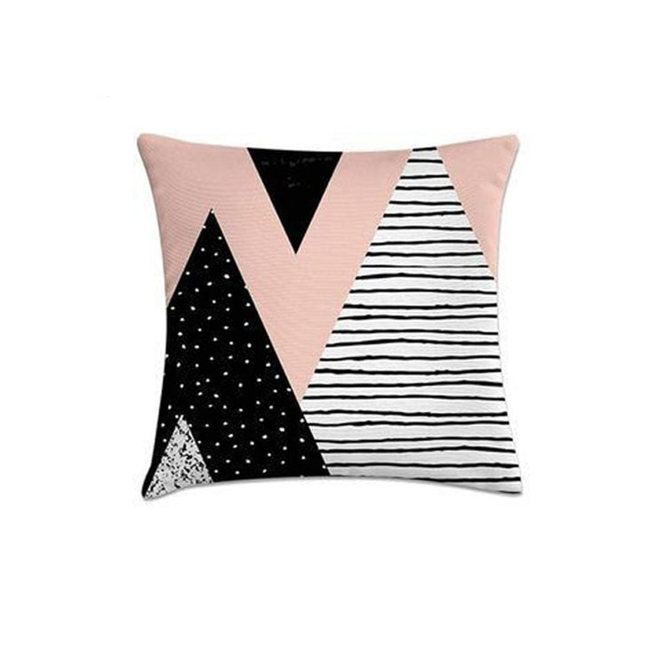 Cushion cover with large pink, black and striped white triangles.