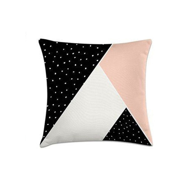 Cushion cover with pink, cream and black dotted triangular panels.