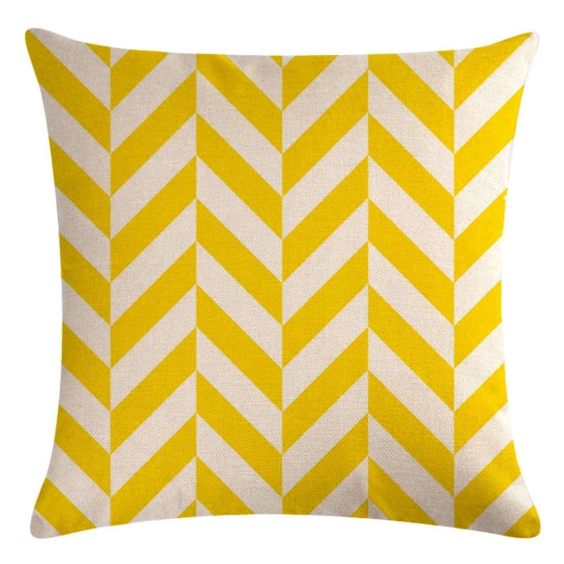Yellow and white cushion cover with broad chevron stripes.