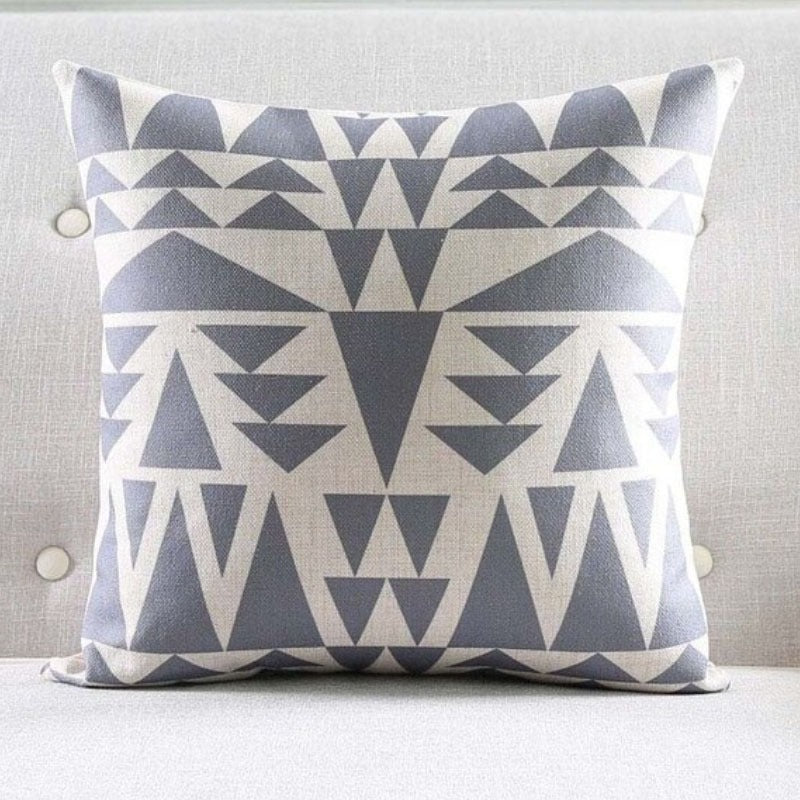 Grey and white cushion cover with horizontal rows of triangular motifs.