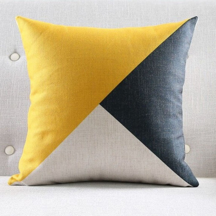 Cushion cover with large yellow, charcoal and cream triangular panels.