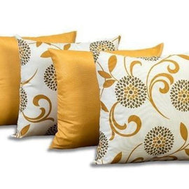 Four mustard and cream cushion covers with plain panels and swirling floral patterns.