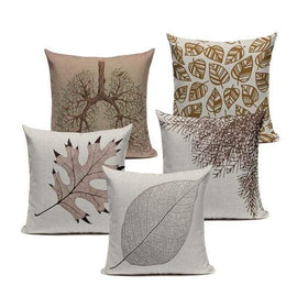 Five neutral cushion covers with leaf silhouettes and delicate botanical patterns.