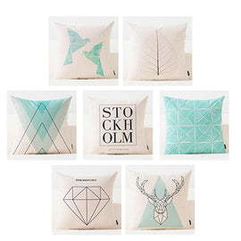 Seven pastel cushion covers with geometric shapes, deer, feathers and Stockholm lettering.