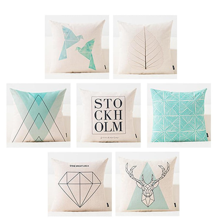 Seven pastel cushion covers with geometric shapes, deer, feathers and Stockholm lettering.