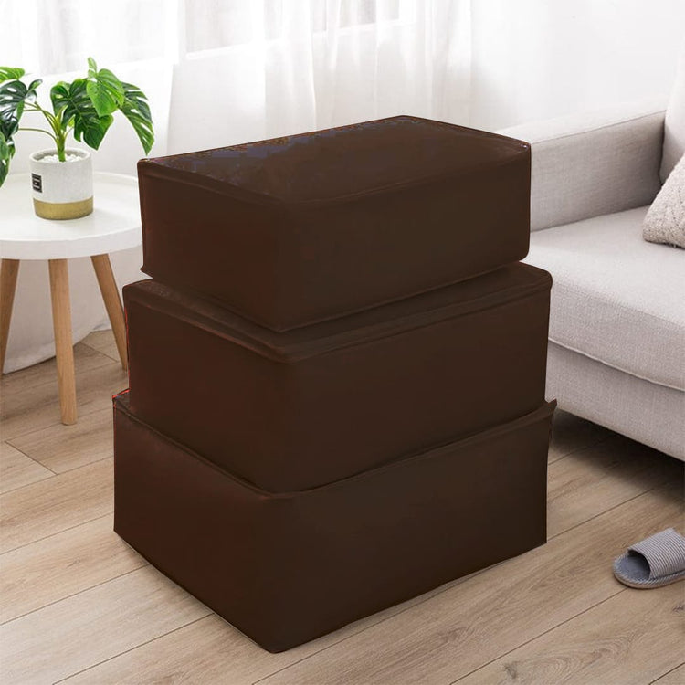 Three brown fabric storage cubes stacked beside a sofa.