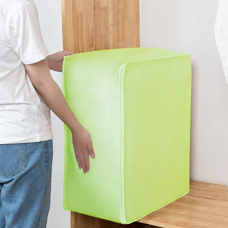 Large lime green fabric storage cube being carried beside a wardrobe.