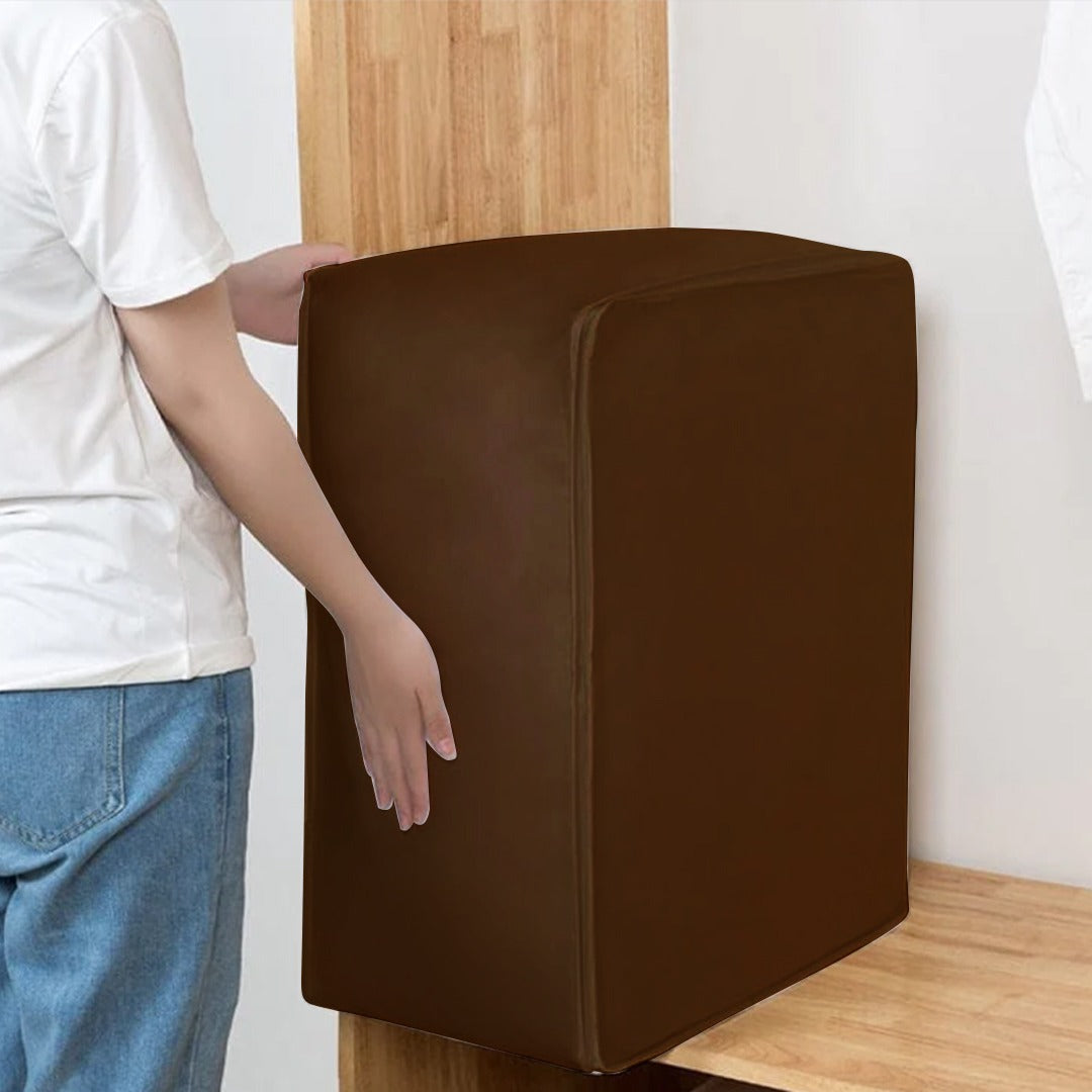 Large brown fabric storage cube being carried beside a wardrobe.