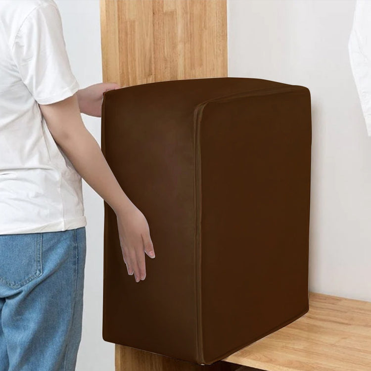 Large brown fabric storage cube being carried beside a wardrobe.