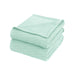 Folded mint green waffle-weave cotton thermal blanket.
