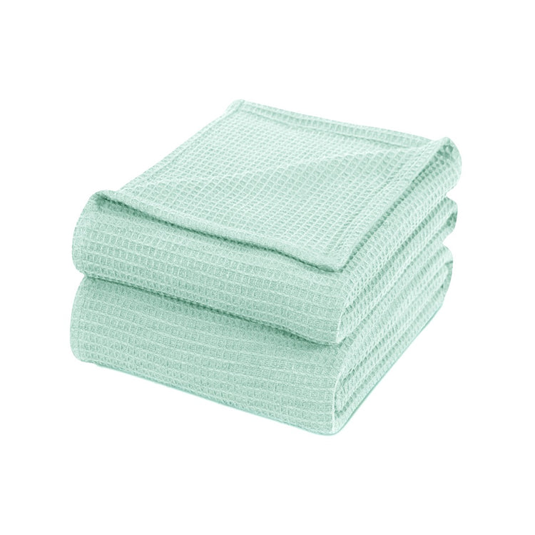 Folded mint green waffle-weave cotton thermal blanket.