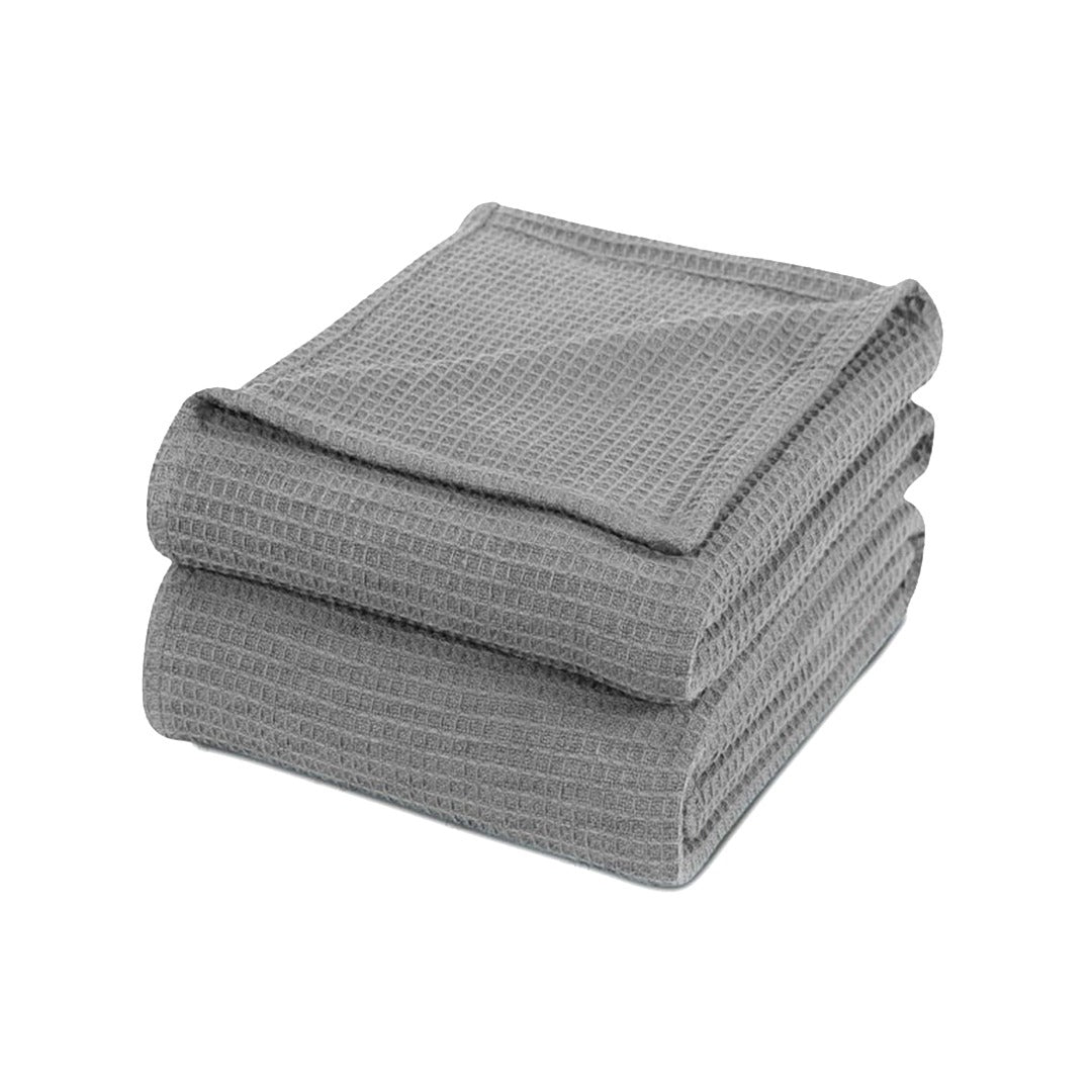 Folded grey waffle-weave cotton thermal blanket.