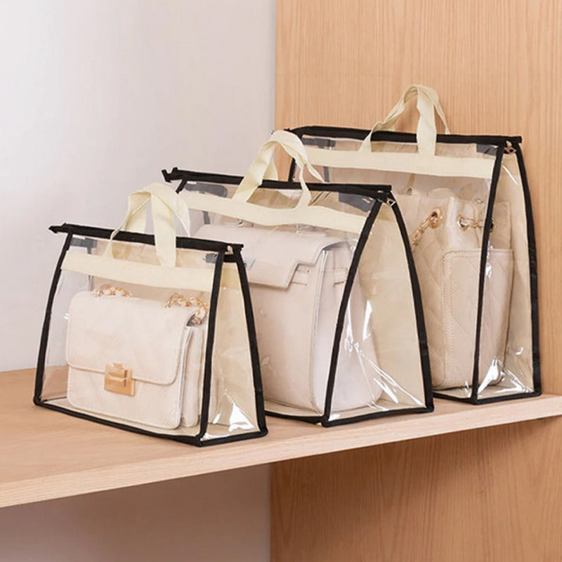Three handbags stored in clear covers with black trim on a shelf.