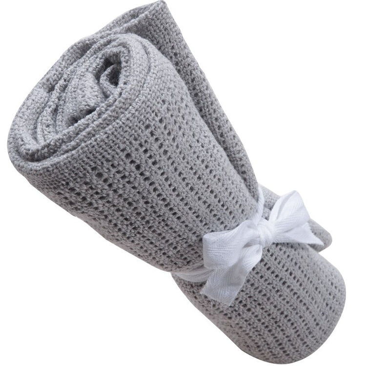 Rolled grey cellular blanket tied with a white ribbon.