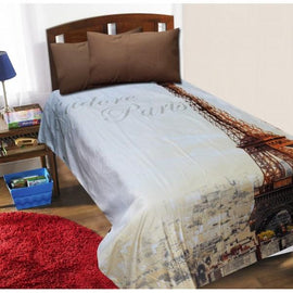 Single bed with an Eiffel Tower print bedsheet and two brown pillows.