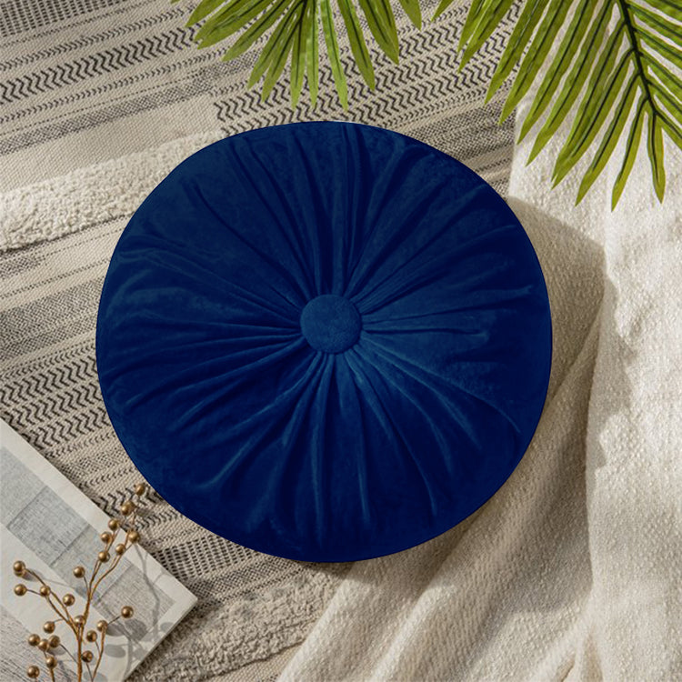 Round blue cushion with radial pleats and a covered centre button.