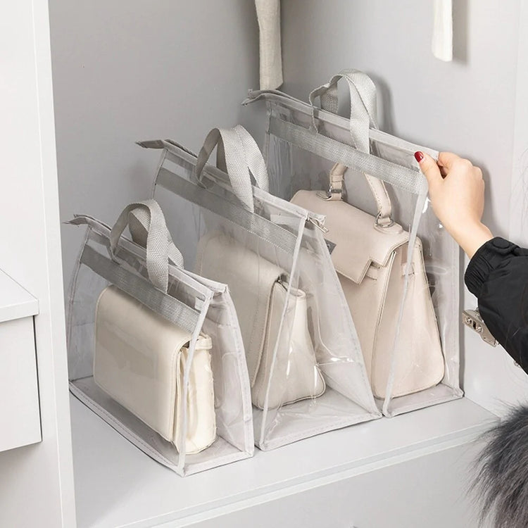 Clear handbag storage covers arranged upright on a wardrobe shelf.