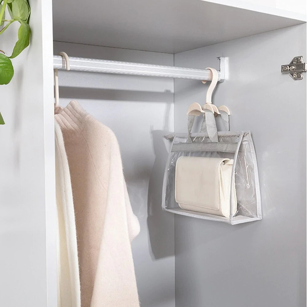 Clear handbag storage cover hanging from a wardrobe rail.